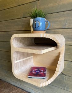 A wall mounted curved bedside table,  made from birch ply. Links to the corresponding product page