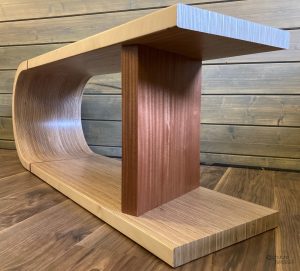 A close corner view of a curved bench made from birch ply with a solid Sapele support. Links to the corresponding product page